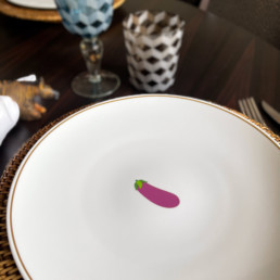 eggplant emoji on a plate