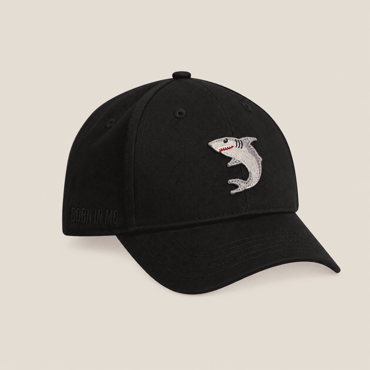 black cap with shark emoji