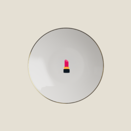 Beefbar x Bernardaud porcelain plate with gold rim and pink lipstick emoji