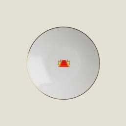 Beefbar x Bernardaud red carpet emoji plate on red velvet under a spotlight